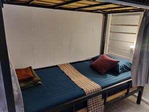 a bed in a bunk bed with pillows on it at Via Hostel Pakse in Pakse
