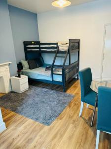 a bedroom with a bunk bed and a table and chairs at London Guest Studios 8 in London