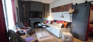 sala de estar con sofá blanco y chimenea en L'Atelier B&B, Amazing view, en Carcassonne