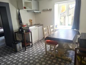 a kitchen with a dining room table and a table and chairs at appartement atypique en triplex in Luze