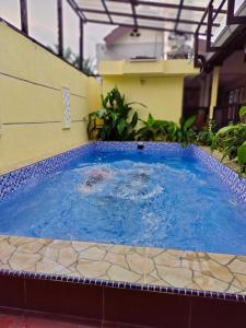 a swimming pool in the middle of a building at Siti Hawa's Cottage in Banting +12 photos