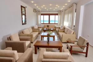 a large living room with couches and a table at Niros Beachfront Aparthotel in Kokkíni Khánion