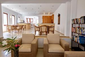 a living room with two couches and a dining room at Niros Beachfront Aparthotel in Kokkíni Khánion