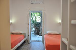 A bed or beds in a room at Alexandra Mykonos Port