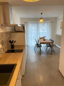 a kitchen with a table and a dining room at Appartement Chez Maria in Guebwiller