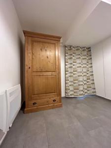 a room with a wooden cabinet in the corner at Appartement Chez Maria in Guebwiller