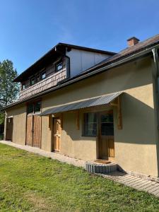 a house with a grass yard in front of it at Chata nad Osławą in Zagórz