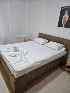 a bedroom with a bed with a doll on it at Aparthotel Raikov Ski Lodge in Pamporovo