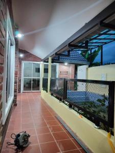a balcony of a house with a spider on the floor at Siti Hawa's Cottage in Banting