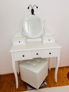 a white dressing table with a mirror on it at Villa Cvetić in Selce