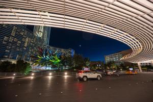 a car parked in a parking lot in a city at night at StripViewSuites at Vdara in Las Vegas