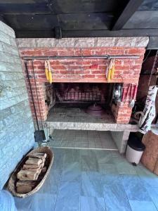 a brick fireplace with a basket in front of it at Apartments Fuma in Otočac