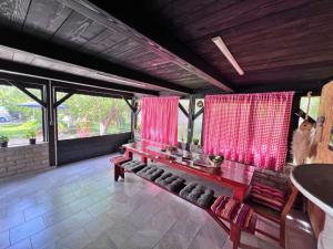 a living room with red curtains and a bench at Apartments Fuma in Otočac