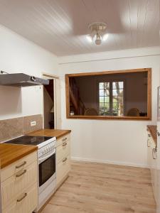a kitchen with a stove top oven next to a window at Maison Papillon in Turenne