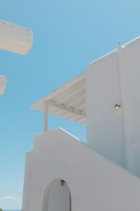 a white building with awning on top of it at Mykonos Pantheon in Kalo Livadi