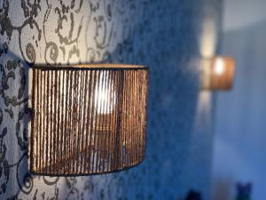 a close up of a lamp on a wall at Skopelos Inn in Stafylos