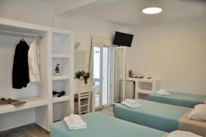 A bed or beds in a room at Alexandra Mykonos Port
