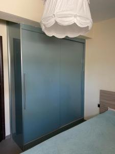 a bedroom with a large blue door with a ceiling at Sea view Villa Sotiritsa in Velika