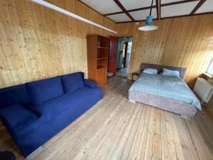 a living room with a blue couch and a bed at Villa Rekin in Gdańsk +12 photos