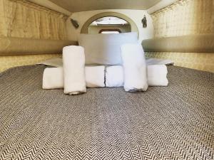 a group of white pillows in an rv at CRUISE BY PORTO RAFTI in Porto Rafti