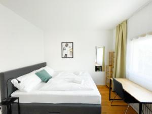 a bedroom with a bed and a window at StayHere City Studio NB 18 - contactless Self-Check-IN in Graz