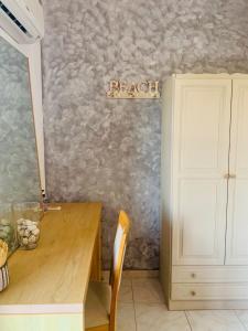 a room with a table and a sign that reads reach at Skopelos Inn in Stafylos