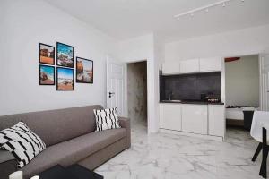 a living room with a couch and a kitchen at ML Apartments in Vieste