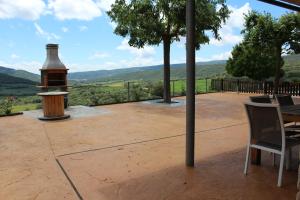 a patio with a bird house and a table and chairs at Vall Farfanya in Tartareu