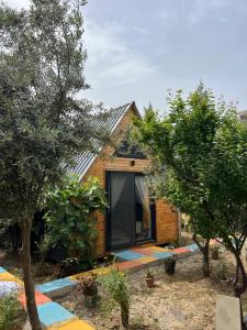 a wooden house with trees in front of it at Karaağaç Bungalov & Tiny House in Hatay
