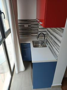 a small kitchen with a sink and a window at Dika Alpha Residence in Saturn