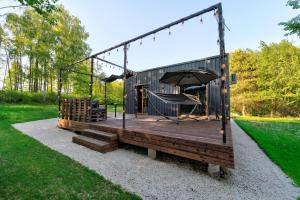 a house with a deck with a swing at RoyalRelax Apartament w Lesie z Jacuzzi, Kinem domowym 88' - Białystok in Choroszcz