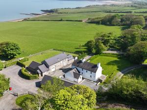 an aerial view of a house in the middle of a field at Penrhyn Farm in Penrhos-Lligwy