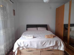 a bedroom with a bed with two baskets on it at Cika Apartment in Kumanovo
