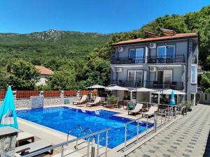 a house with a swimming pool next to a building at Villa Mimi in Peštani +54 photos