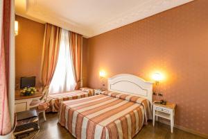 Postelja oz. postelje v sobi nastanitve Hotel La Lumiere Di Piazza Di Spagna