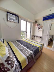 a bedroom with a bed and a tv on the wall at Casa Concha by Celandine in Manila +19 photos