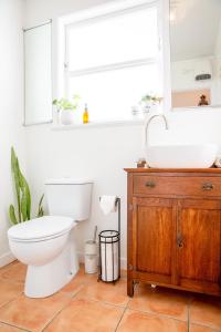 a bathroom with a toilet and a sink at Grace Road Cottage in Tauranga