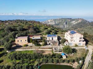 una vista aérea de una casa en una colina en Agriturismo Sant'Anna Ortì in oliveta biologica con vista sullo Stretto di Messina en Orti