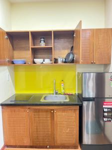 a kitchen with a sink and a refrigerator at NEW LAND Apartment - Nam Thong 3, Phu My Hung in Ho Chi Minh City