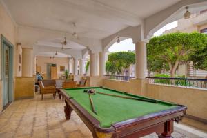 a pool table in the middle of a room at Villa Khufu Pyramids Inn in Cairo