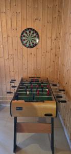 a room with a pool table and a dart board at Domki u Danusi z widokiem na wodę in Lipusz