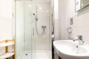 a white bathroom with a sink and a shower at Duke House ground floor Apartment in Padstow +42 photos