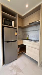 a kitchen with a refrigerator and a sink at Rocco Apartments a Cosy Luxury Stay Holiday Home in Krabi in Ao Nang Beach
