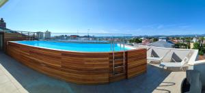 a swimming pool on the roof of a building at Wally Residence in Rimini