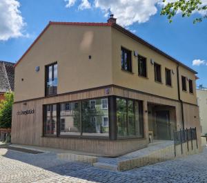 布格哈斯拉赫das herzstück - Schaubrennerei, Hausbrauerei & Apartments的街道上带窗户的大型建筑