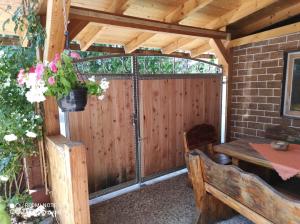eine abgeschirmte Veranda mit einem Tisch und einer Bank in der Unterkunft FeWo Am alten Holzplatz in Drübeck