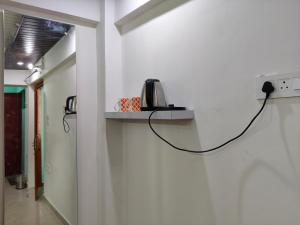 a phone on a shelf on a wall at Him-Kim Homestays in Badrinath