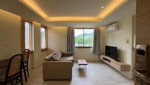 a living room with a couch and a tv at Rocco Apartments a Cosy Luxury Stay Holiday Home in Krabi in Ao Nang Beach