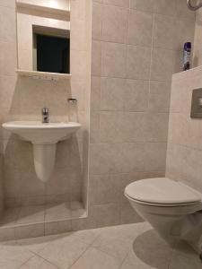a bathroom with a toilet and a sink at Hotel Promenade in Palanga