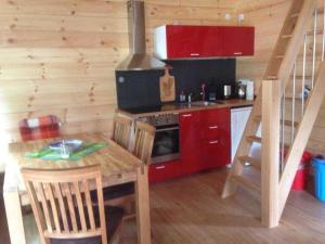 a small kitchen with a table and a stove at Ferienhaus Ronja in Hemfurth-Edersee